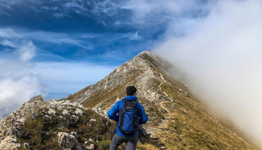 West Balkans hiking - man in blue jacket and gray pants hiking